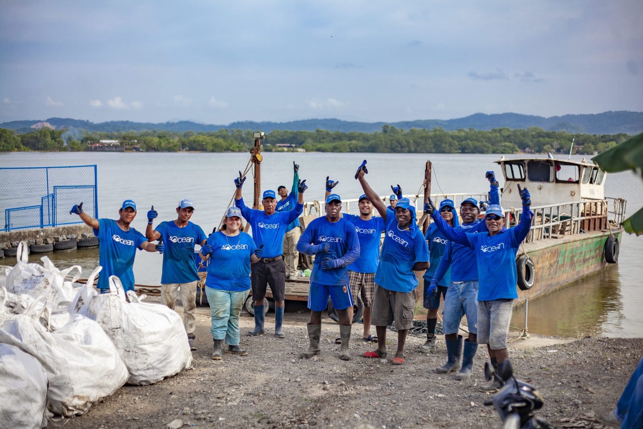 4 ocean team next to the water
