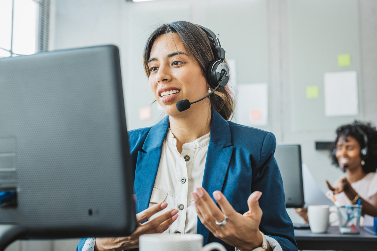 Woman speaking on a headset on her computer