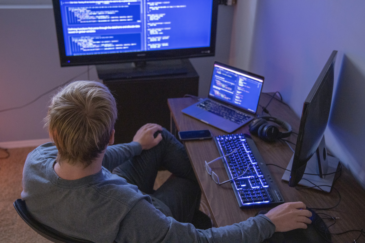 Man looking at computer screens