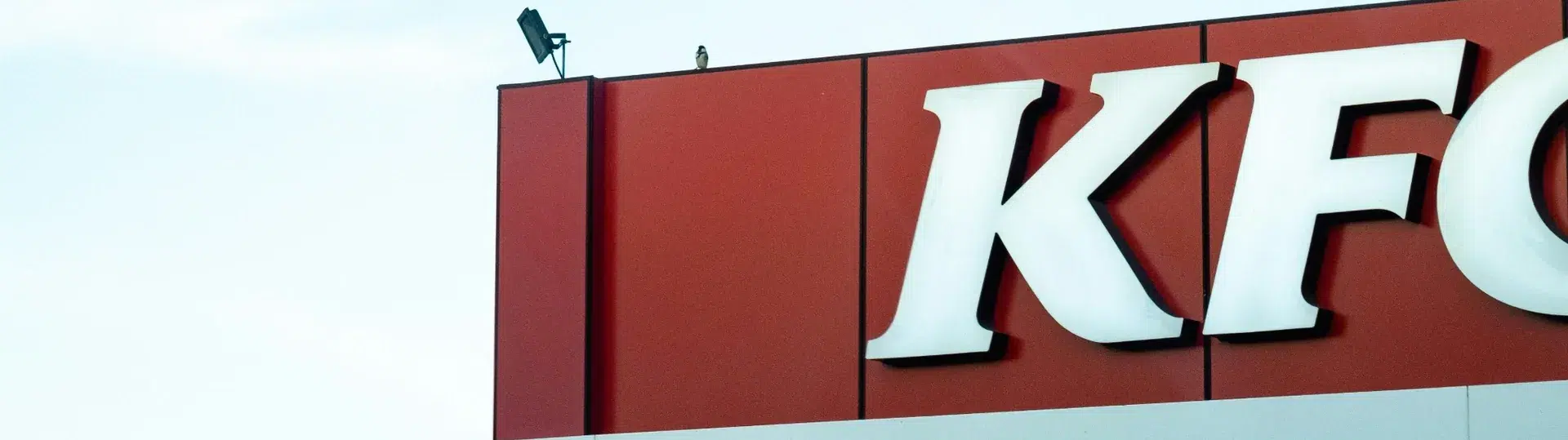 KFC storefront signage with iconic Colonel Sanders logo and branding