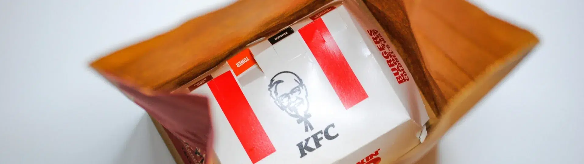 KFC branded takeout bag and box displaying consistent brand identity across packaging