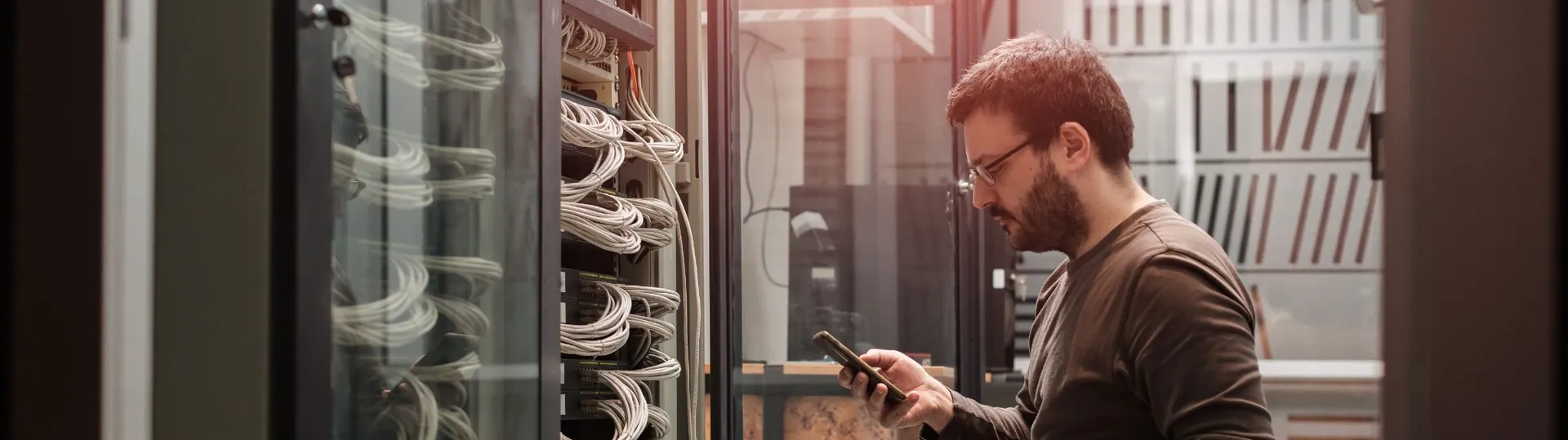 IT technician inspecting server equipment in data center