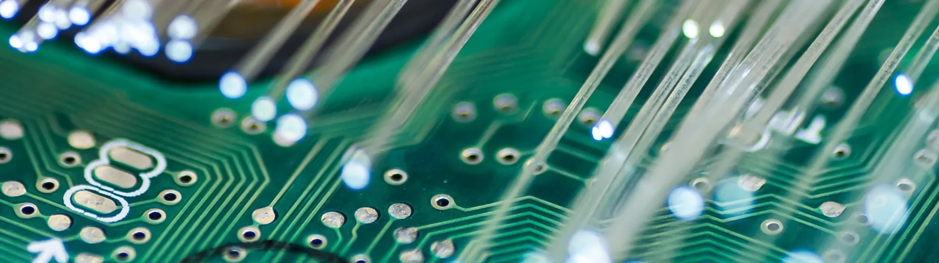 Close-up of fiber optic cables connected to circuit board showing network infrastructure