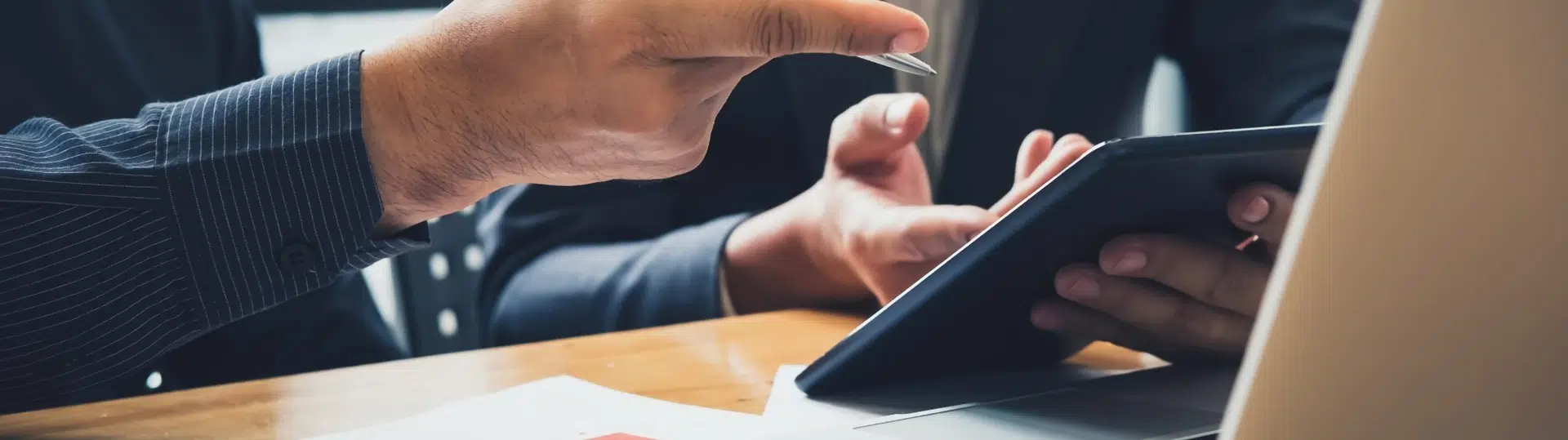 Business professionals reviewing financial data on tablet