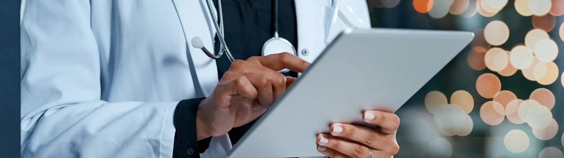 Healthcare professional using tablet for patient care management