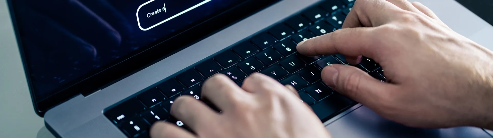 Person typing on laptop with glowing AI prompt search bar on screen