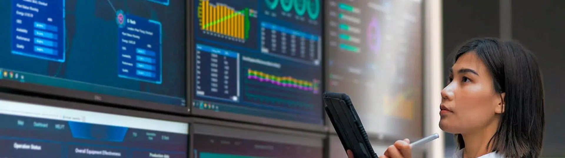 Analyst reviewing cloud automation dashboards and performance metrics on multiple screens