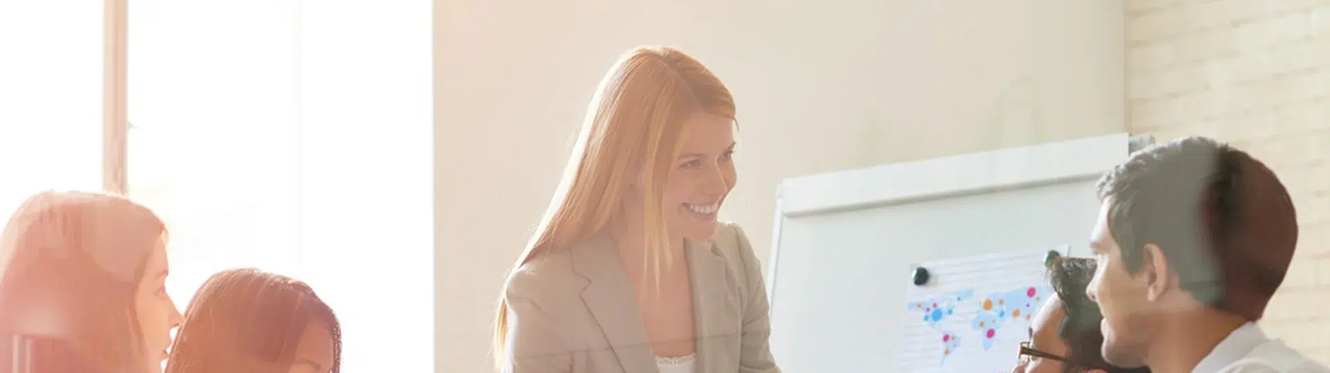 Business leader presenting technology strategy to a seated team in a bright modern office
