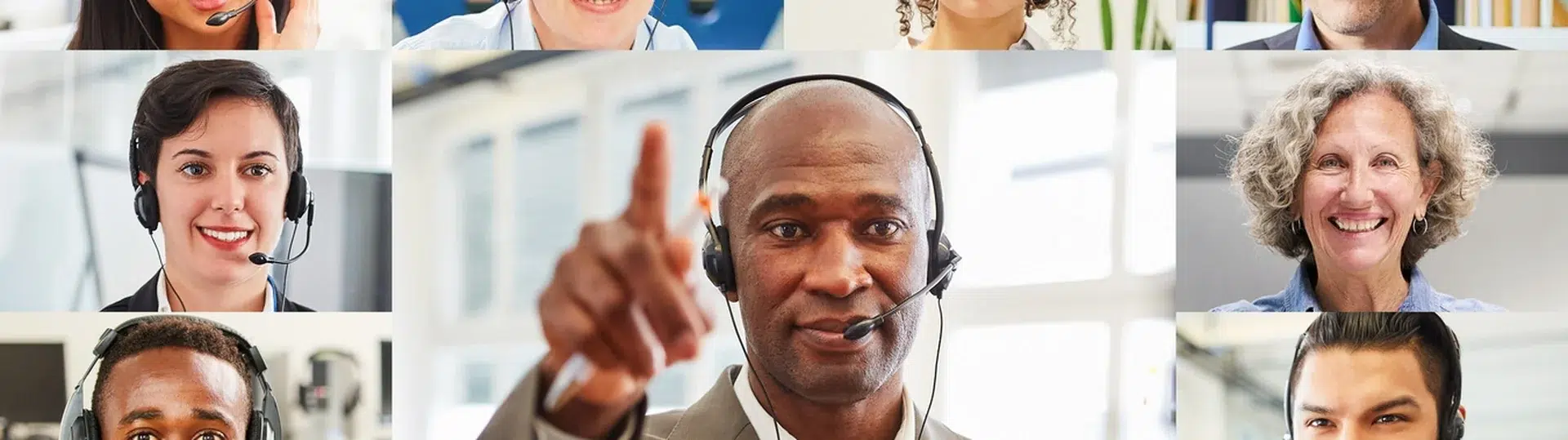 Diverse team of professionals collaborating via video conference with multiple participants on screen wearing headsets