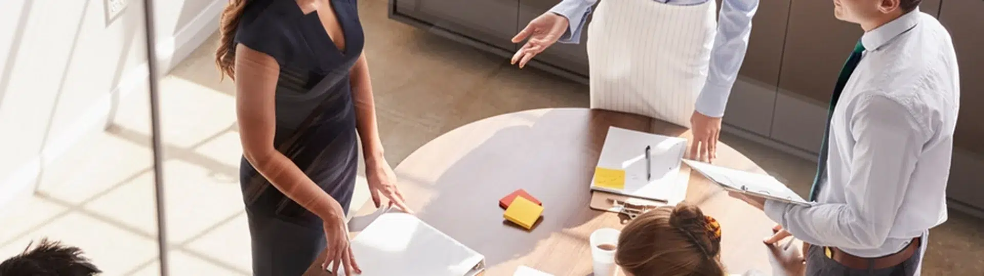 Overhead view of an executive team gathered around a round conference table for a collaborative strategy session
