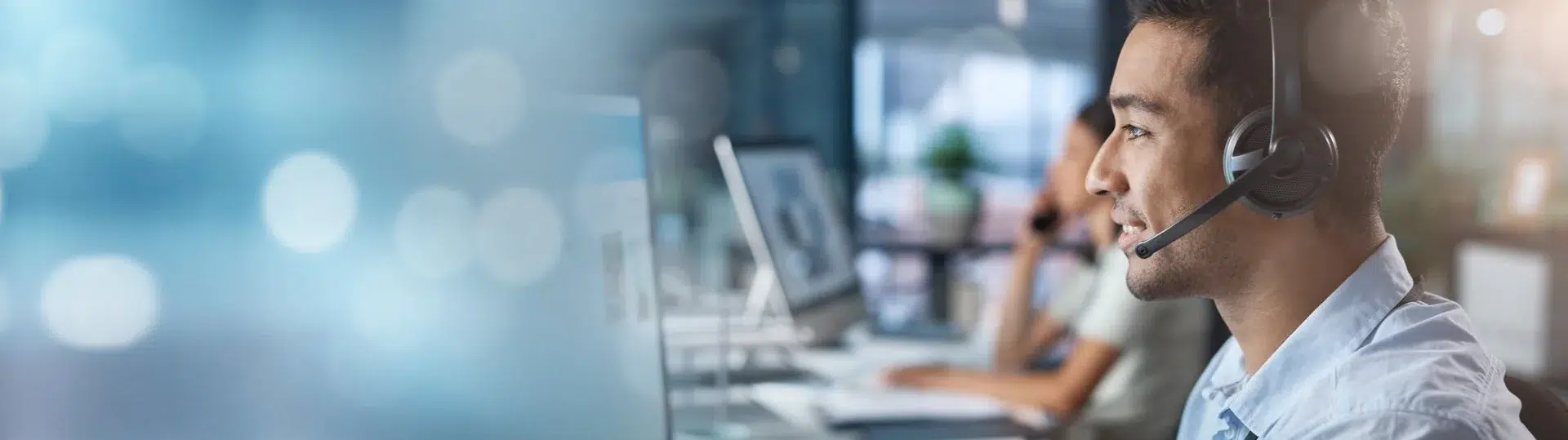 LATAM tech professional wearing a headset at a support workstation representing nearshore talent solutions