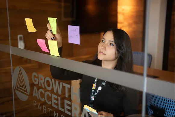 Engineer planning roadmap at whiteboard with sticky notes
