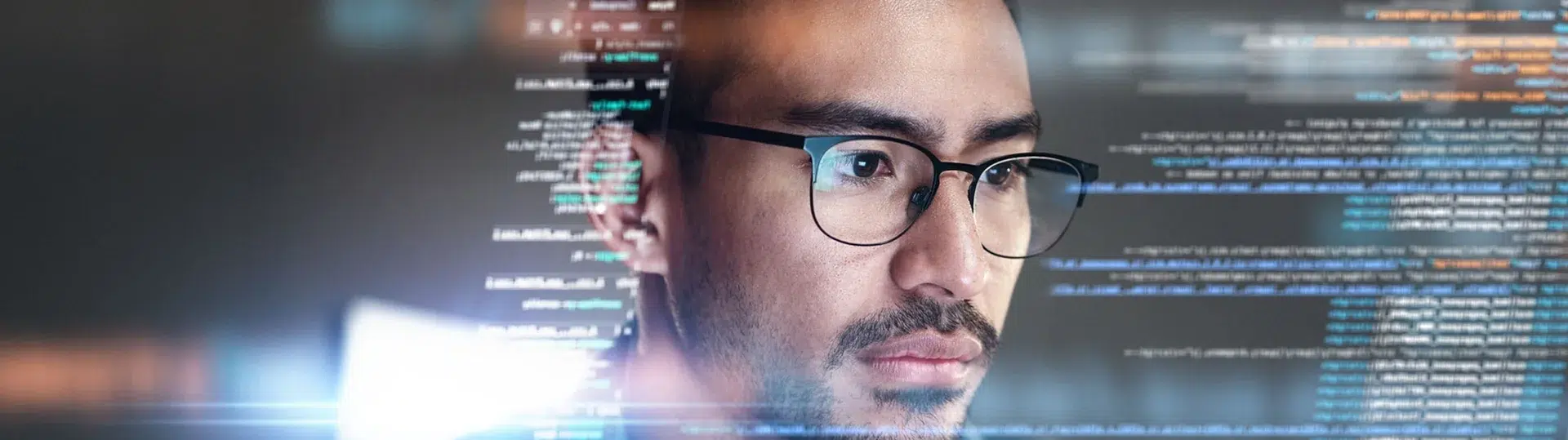 Software developer studying a digital code overlay on screen representing LATAM nearshore engineering expertise