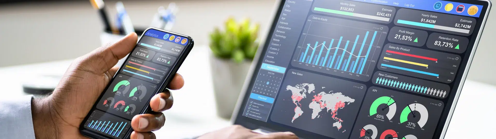 Analytics dashboard displayed on both a mobile phone and laptop screen showing IoT data metrics and KPIs