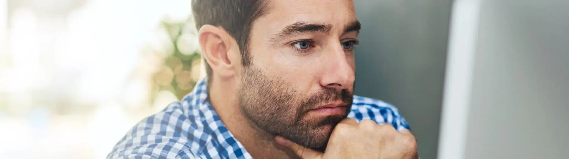 Engineer thoughtfully reviewing cloud architecture plans at a computer