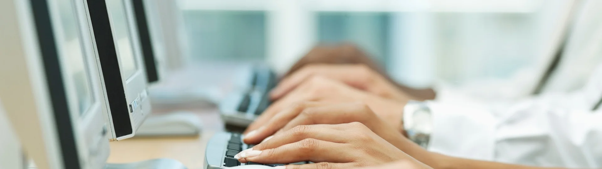 Hands typing on keyboard for remote work and digital collaboration
