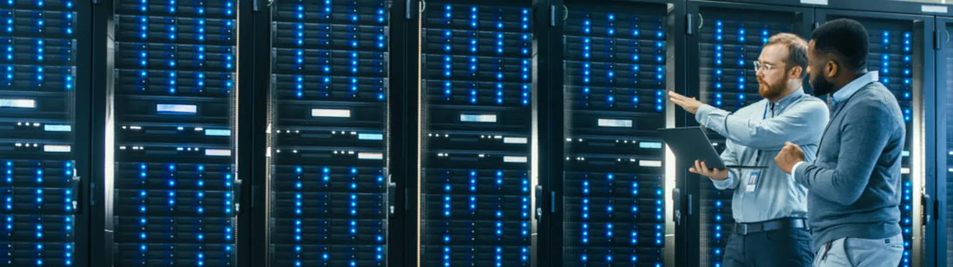 IT engineers reviewing server infrastructure during a technology application assessment
