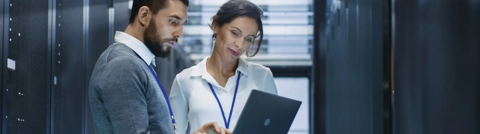 IT engineers working with laptop in server room data center