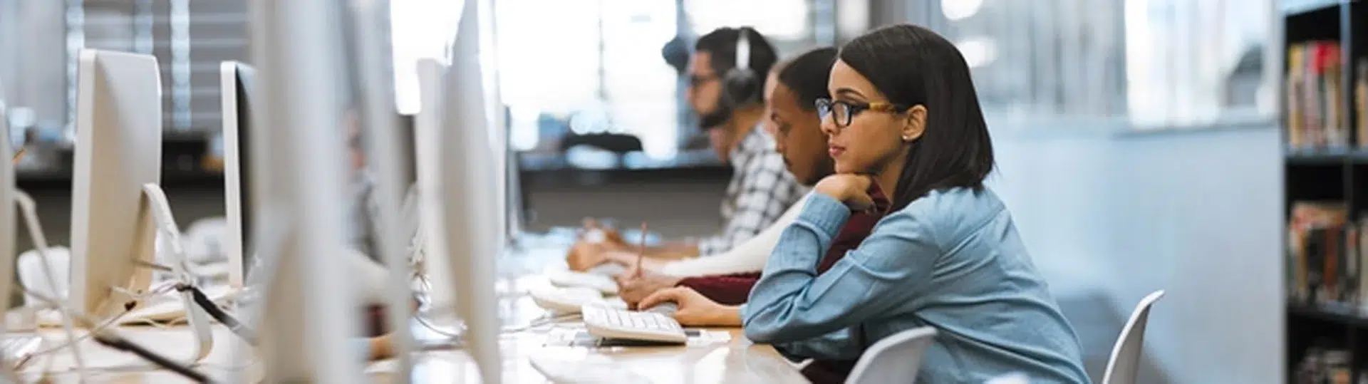 QA professionals working focused at computers running software tests