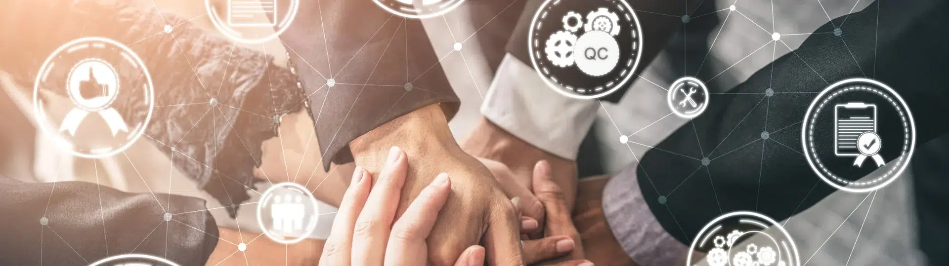 Diverse QA team with hands stacked together surrounded by quality assurance and QC icon network overlay