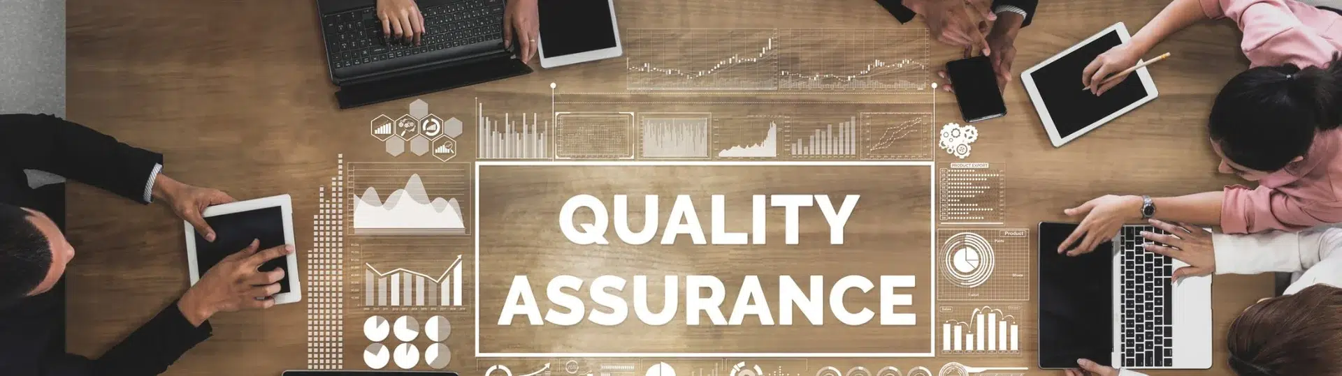 Overhead view of a quality assurance team meeting around a conference table with data visualization overlays