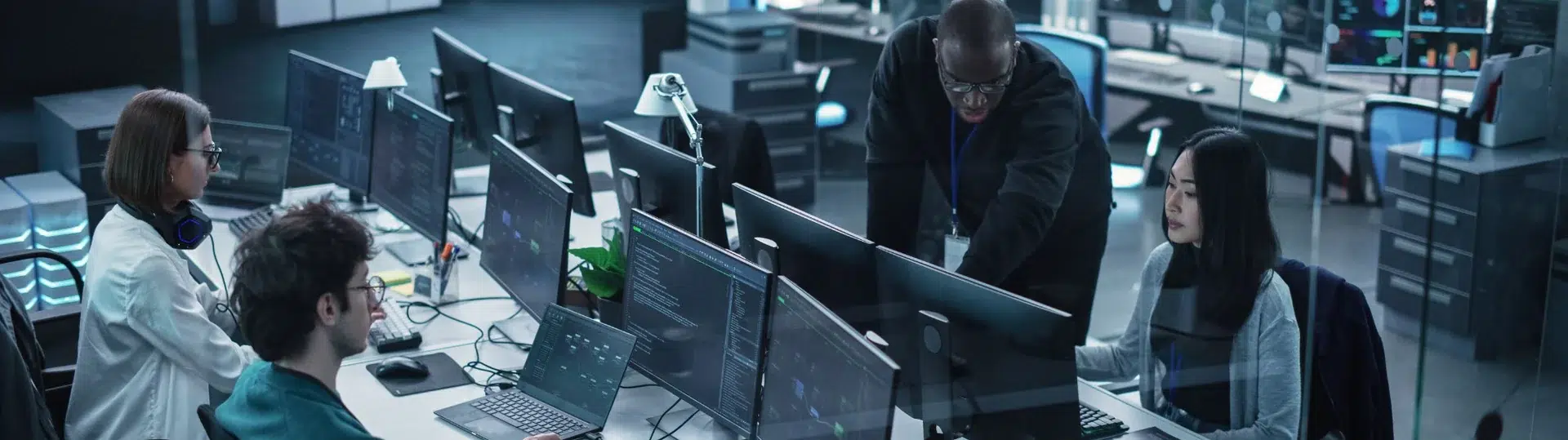 Software engineering team working at workstations in a modern open-plan technology office