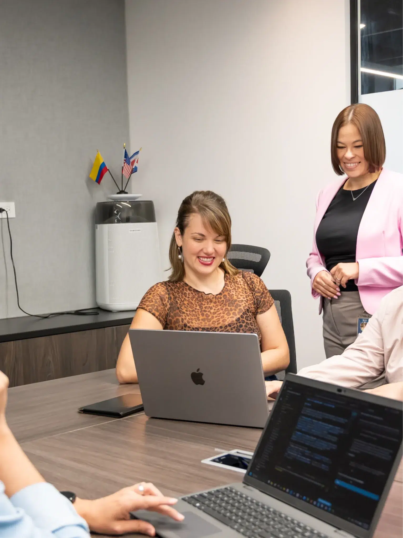 GAP colleagues laughing together over a laptop in a GAP meeting room